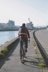 Spain, Bilbao, Zorrozaurre, back view of man riding racing cycle on bicycle lane - RTBF000100