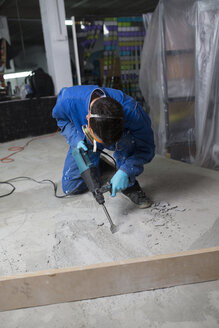 Worker treating the cement floor with a jackhammer - RAEF001031