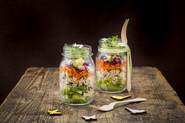 Springtime salad in glasses, lettuce hearts, radicchio, avocado, carrot, zucchini, wild rice and cress, daisy - LVF004730
