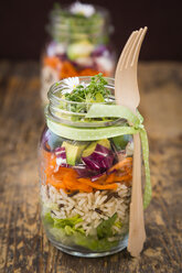 Springtime salad in glasses, lettuce hearts, radicchio, avocado, carrot, zucchini, wild rice and cress, daisy - LVF004732