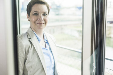 Portrait of confident businesswoman at the window - UUF006778