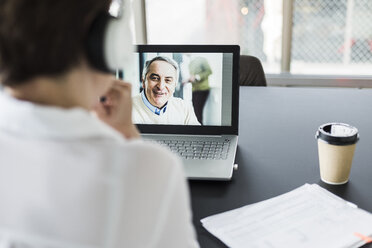 Businesswoman having a video conference in office - UUF006826