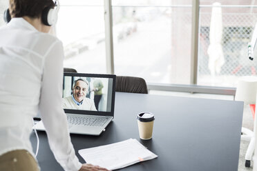 Businesswoman having a video conference in office - UUF006827