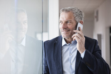 Successful businessman standing in his office - RBF004318