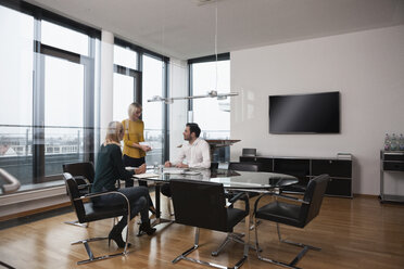 Business people having a meeting in conference room - RBF004410