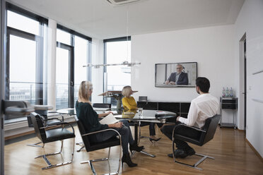 Business people having a video conference in board room - RBF004411