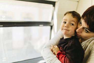 Little boy enjoying his first train ride with his mother - JRFF000539