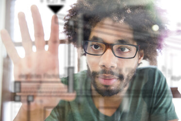 Young man using transparent touchscreen display - FKF001818