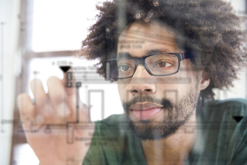 Young man using transparent touchscreen display - FKF001819