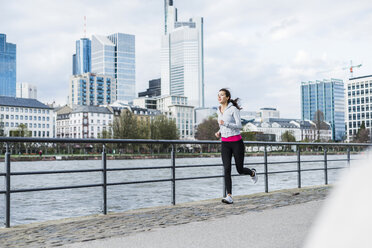 Young woman running at the river - UUF006951