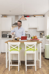 Man standing in his kitchen pouring espresso into cup - BOYF000273