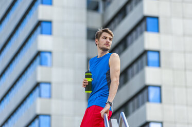 Young sporty man with water bottle and smartwatch - DIGF000261