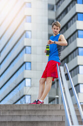 Young sporty man with water bottle and smartwatch - DIGF000262
