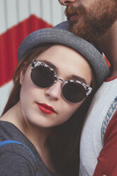 Portrait of young woman wearing sunglasses leaning agaich her boyfriend - RTBF000118