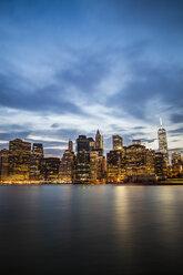 USA, New York City, Blick von Brooklyn auf die beleuchtete Skyline von Manhattan und den East River in der Abenddämmerung - GIOF000884