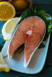 Raw salmon fillet on plate, salt and lemon - KIJF000322