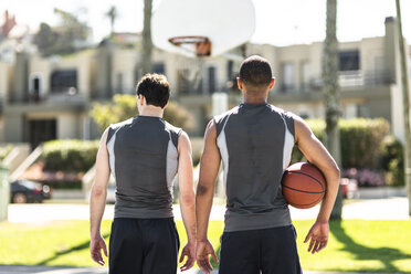 Rear view of two basketball players outdoors - LEF000111