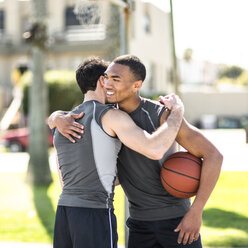 Two basketball players embracing outdoors - LEF000114
