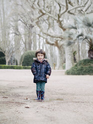 Portrait of smiling little boy standing in park in winter - XCF000079