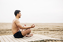 Young man practicing yoga, relax meditation pose Stock Photo by ©Milkos  198570800