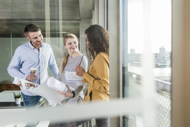 Three colleagues discussing plan in office - UUF006969