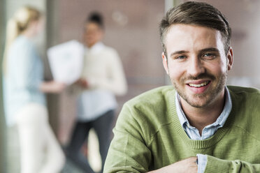 Portrait of smiling young man in office - UUF007005