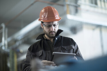 Young technician working with tablet pc - SGF002031