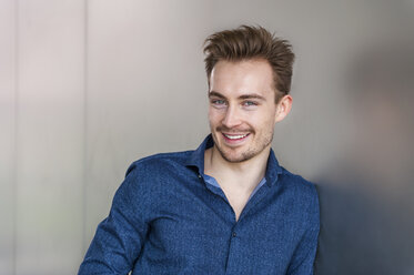 Portrait of smiling young businessman with stubble - DIGF000309