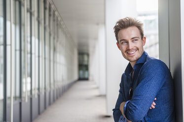 Portrait of relaxed young businessman with crossed arms - DIGF000315