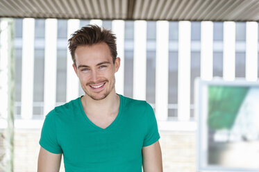 Portrait of smiling young man with stubble - DIGF000319