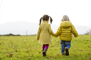 Vietnamese girl and caucasian boy playing outdoor in fall season - ZOCF000044