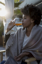 Young woman sitting in bar drinking aperitif - MAUF000489