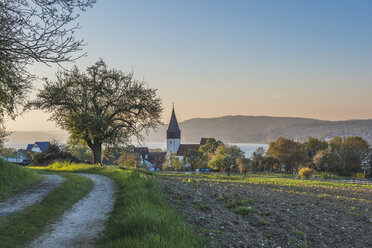 Germany, Dingelsdorf, View to St. Nicholas' Church in the evening - KEBF000382