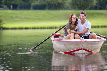 Young couple having fun in a rowing boat on lake - ZOCF000062