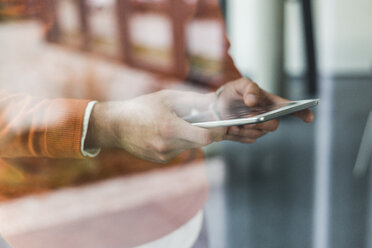 Close-up of man using phablet - UUF007093