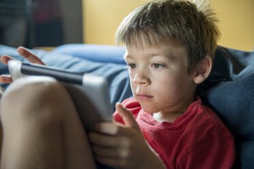Young boy using digital tablet at home - ZOCF000072