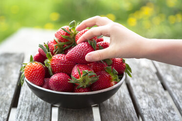 Girl's hand taking strawberry - SARF002706