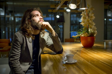 Young hipster businessmamn waiting in cafeteria - ZOCF000103