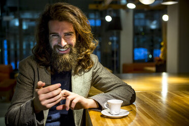 Young hipster businessmamn waiting in cafeteria - ZOCF000104