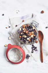 Preserving jar of overnight oats with pineapple, coconut, chia pudding, hazelnuts and berries - SBDF002799