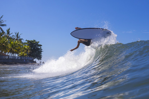 Indonesien, Bali, Surfer auf Welle, lizenzfreies Stockfoto