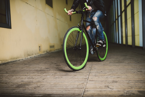 Young man riding fixie bike stock photo