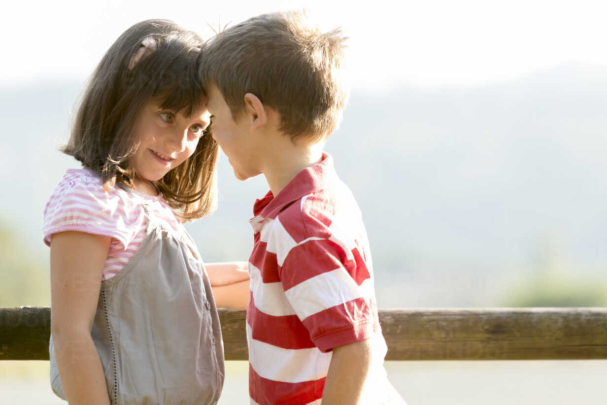 Little boy and girl face to face stock photo