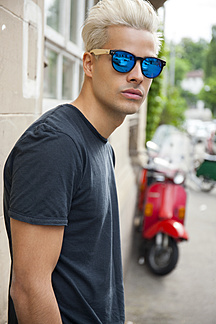 Portrait of young man wearing mirrored sunglasses stock photo