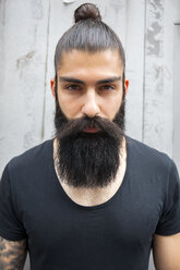 Portrait of young man with full beard and bun - CHAF001667