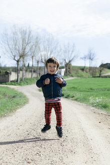 Portrait of happy little boy jumping in the air - XCF000084