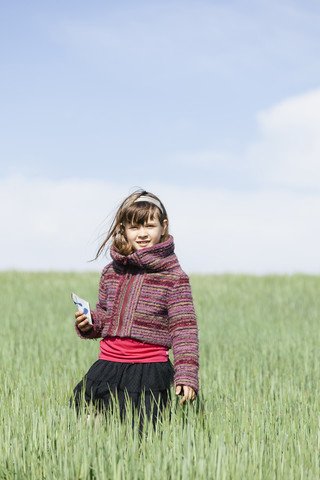 Portrait of little girl standing in a grain field stock photo