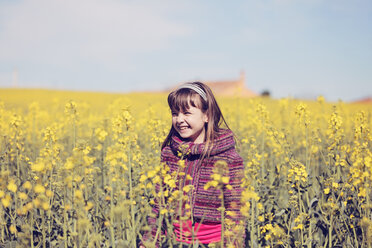 Portrait of little girl standing in front of rape field - XCF000087