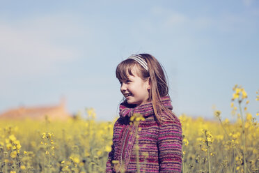 Portrait of little girl standing in front of rape field - XCF000088