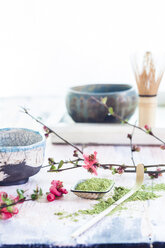 Matcha tea in bowl, with match powder, spoon and chasen and pink flowers - SBDF002858